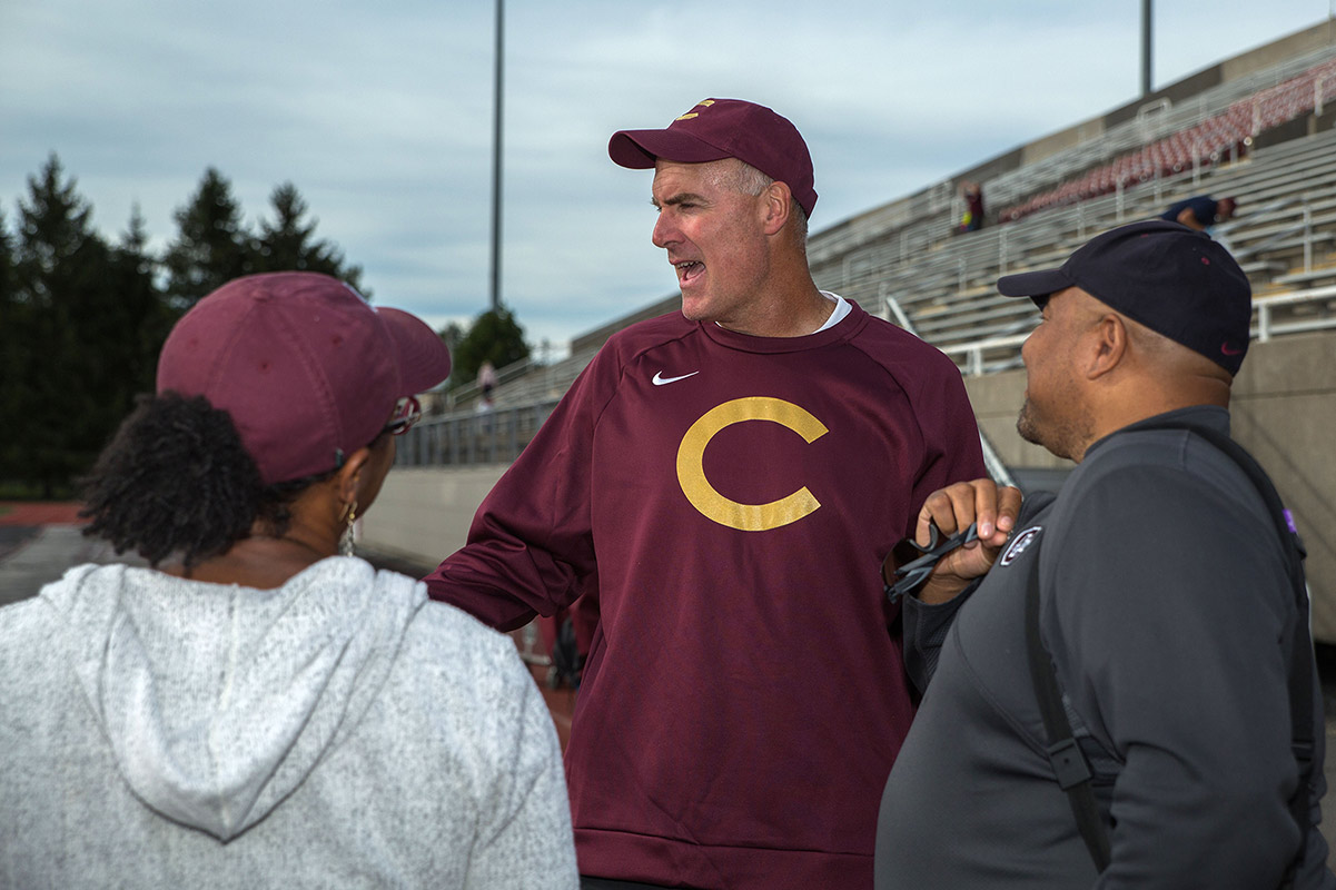 Man in Colgate hat and sweater