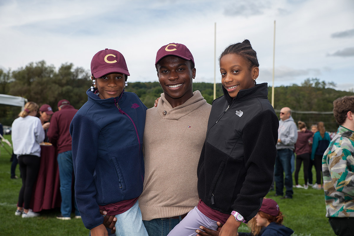 Man with two daughters in Colgate hats