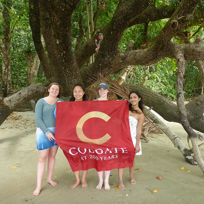 Students on beach with flag