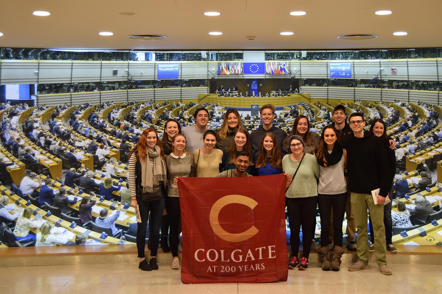 Students with flag in front of UN assembly floor