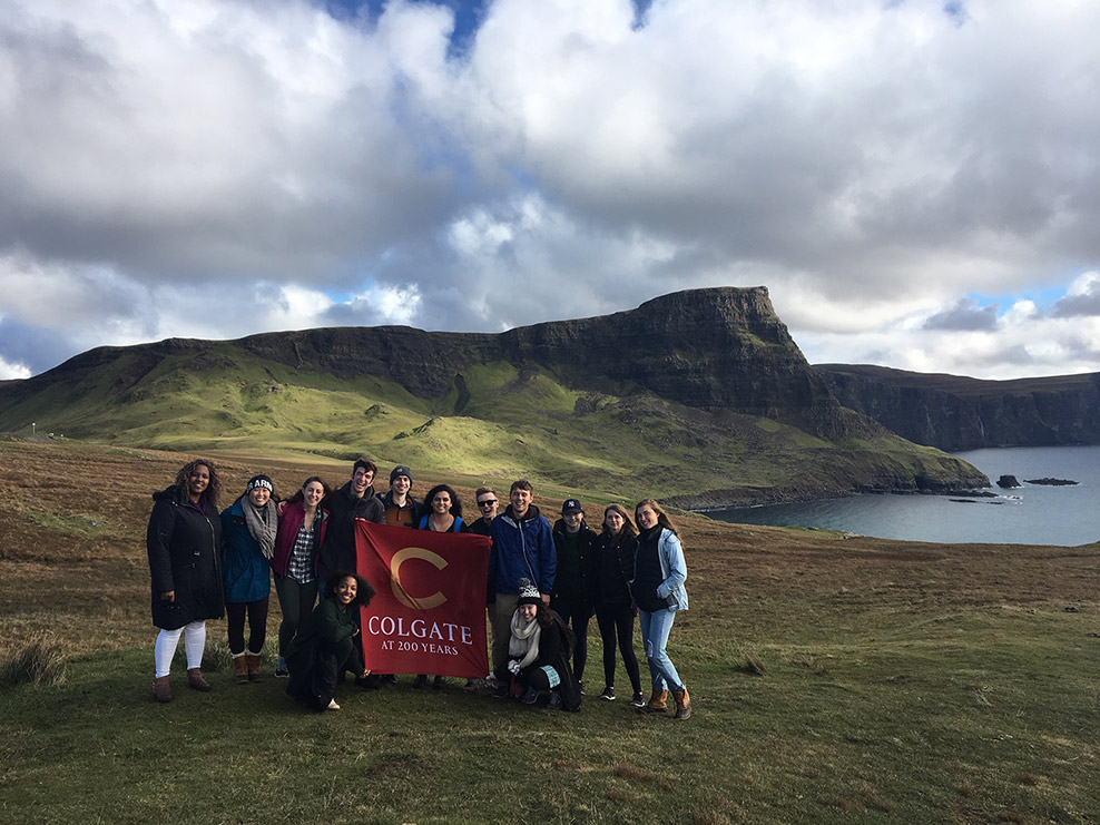 Students with Banner in front of lake